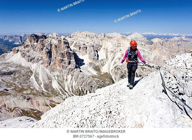 Mountain climber ascending Tofane di Rozes Mountain along the Via Ferrata Giovanni Lipella climbing route, Dolomites, Belluno province, Italy