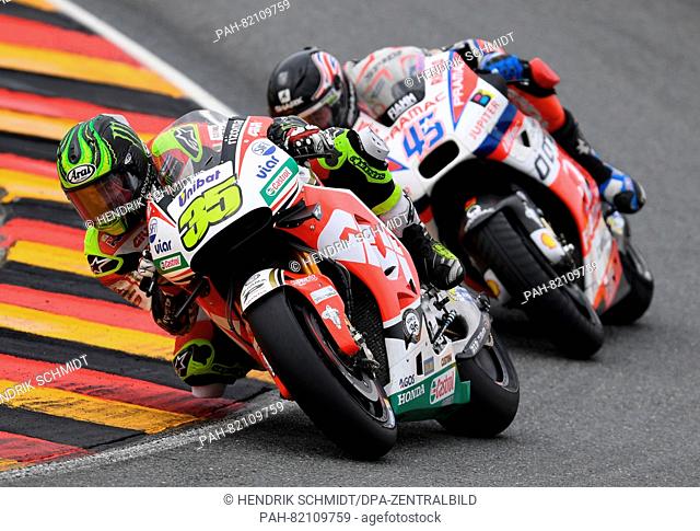 British MotoGP rider Scott Redding from OCTO Pramac Yakhnich Team (r.) with the British Cal Crutchlow from the LCR Honda team during the Motorcycle World...