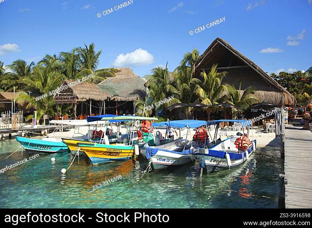 Traditional boats at North Beach-Playa Norte in front of the typical houses near the town center, Isla Mujeres, Cancun, Quintana Roo, Mexico, Central America