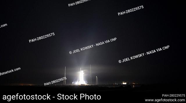 NASA’s Space Launch System (SLS) rocket with the Orion spacecraft aboard is seen illuminated by spotlights atop a mobile launcher at Launch Complex 39B, Friday
