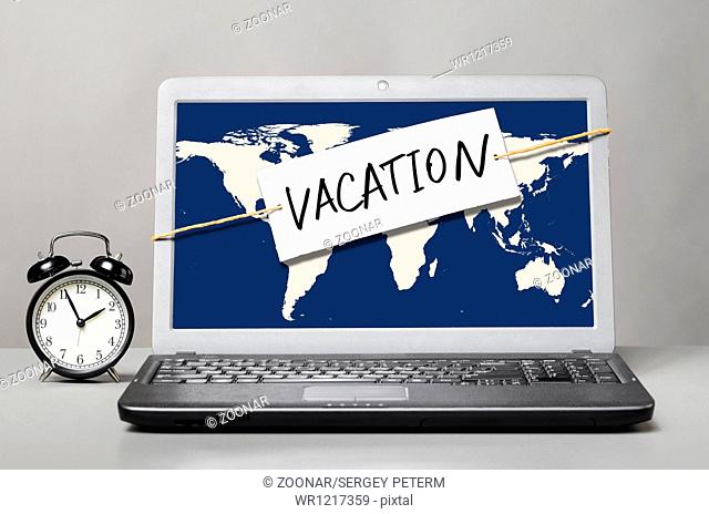 laptop with vacation note