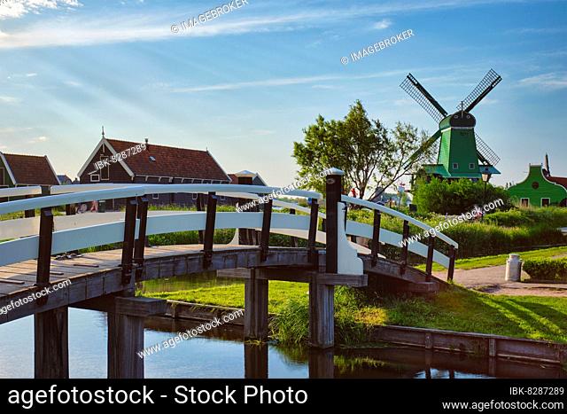 Netherlands rural lanscape with bridge over canal at windmills at famous tourist site Zaanse Schans in Holland Zaandam, Netherlands With camera panning