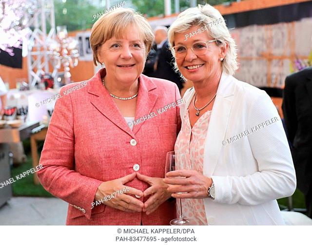 German Chancellor Angela Merkel (CDU, l) speaking with the former coach of the German national women's soccer team Silvia Neid at the 'BILD100' reception of...
