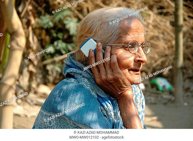An elderly woman using cell phone Faridpur, Bangladesh January 28, 2008