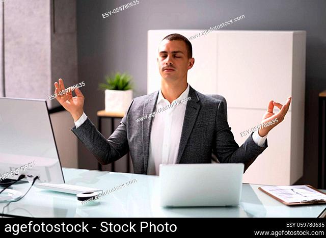 Yoga Meditation Exercise In Office. Male Business Man Meditating