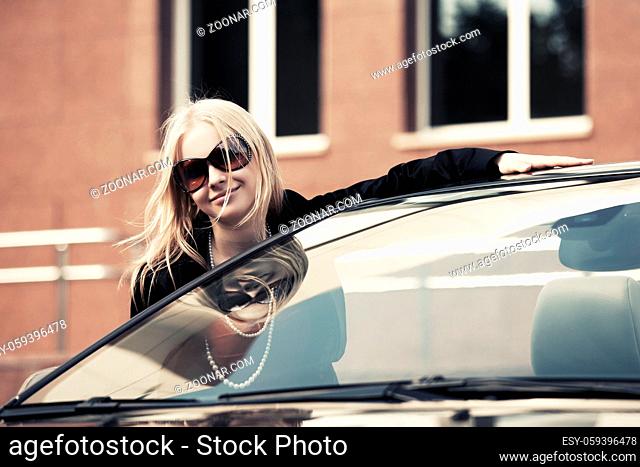 Happy young fashion woman at the convertible car