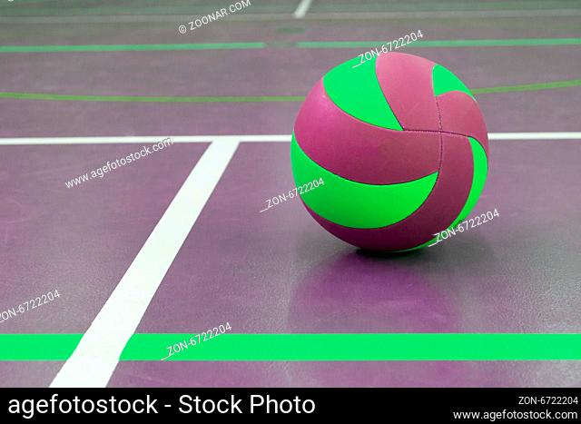 Green and purple ball on court at break time, school gym