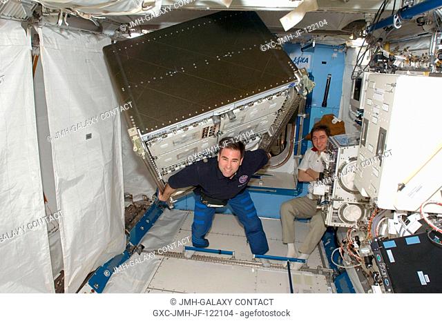 Thanks to the weightlessness of space, astronaut Greg Chamitoff, Expedition 17 flight engineer, isn't toting the excessive weight load he appears to be in this...