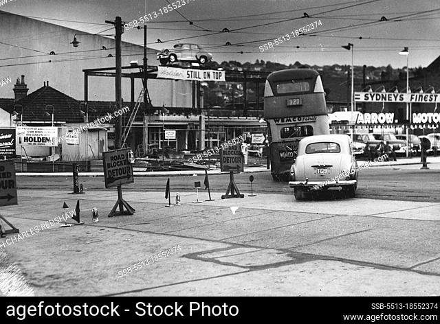 Road blocks in New South Head Rd. Double Bay divert traffic behind shopping centre, where tram line repairs are in progress. January 20, 1955