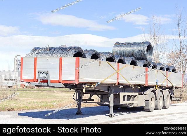 Steel Wire Rolls. Steel wire rolls industrial construction products on transport trailer