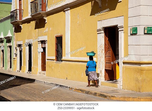 Indigenous woman walking in the street at the historic center of Campeche, Campeche, Yucatan, Mexico, Central America