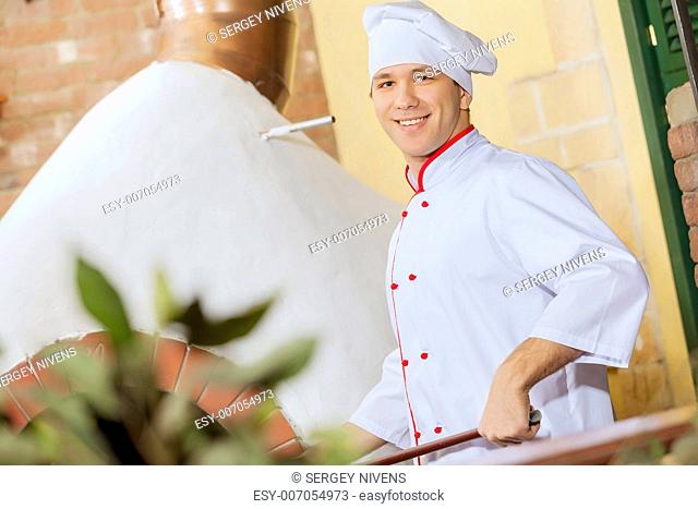 Image of young handsome male cook at kitchen