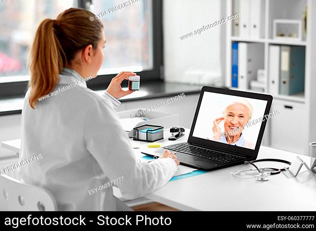 doctor with laptop having video call with patient