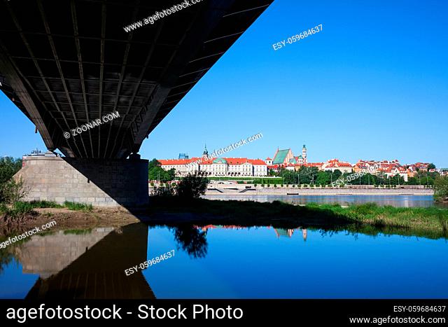 Under the bridge skyline of Warsaw Old Town in Poland, capital city, water of the Vistula River