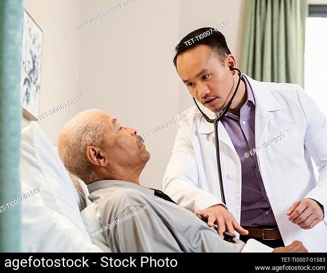 Doctor examining senior man with stethoscope