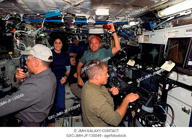 The STS-117 and Expedition 15 crewmembers work various tasks in the Destiny laboratory of the International Space Station during flight day five activities...