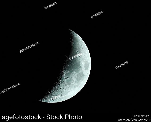 a very sharp close-up of the rising crescent moon in the night sky