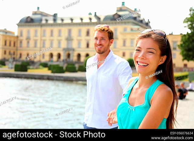 Stockholm couple at Drottningholm palace, Sweden. Tourist people visiting the Queen's royale residence in Stockholm, famous attraction in Sweden