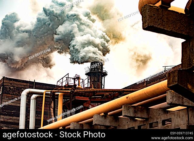 metallurgical plant pollutes the atmosphere. thick smoke from the chimney. Environmental pollution