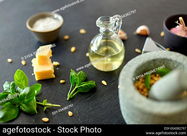 ingredients for basil pesto sauce on stone table