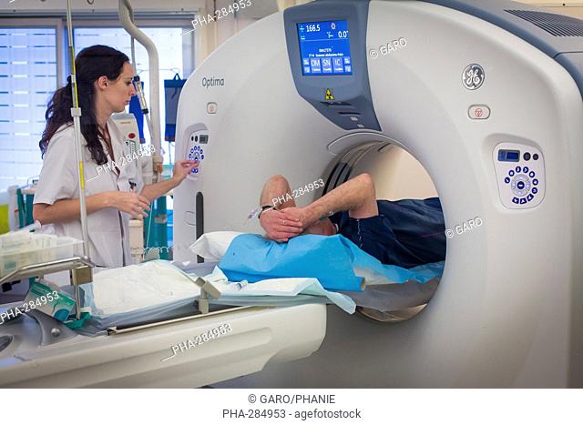 Male patient undergoing a CT scan, Croix Saint Simon hospital, Paris, France