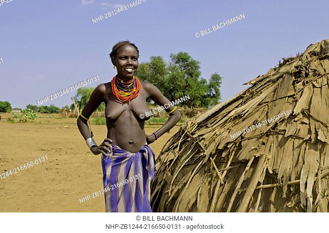 Dassnech tribe in Omorate in Ethiopia Africa in Lower Omo Valley with tribal woman Dassnech topless breasts hut 26