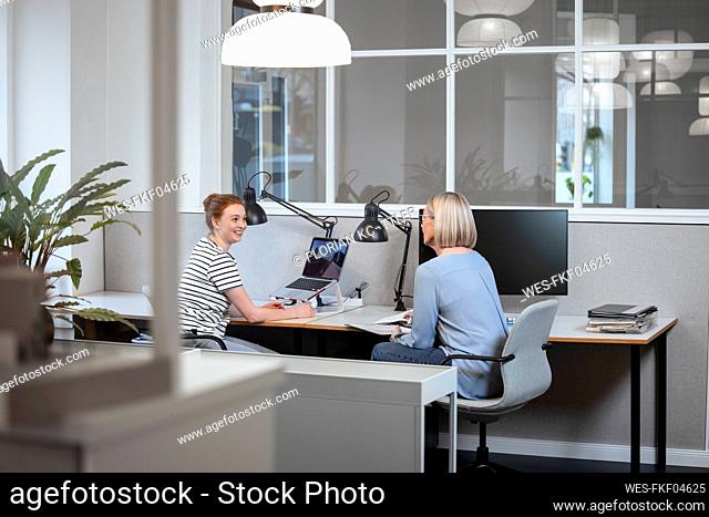 Businesswomen having discussion at workplace