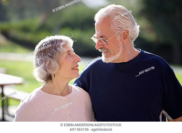 Portrait of active senior couple looking lovingly at each other in an outdoor park