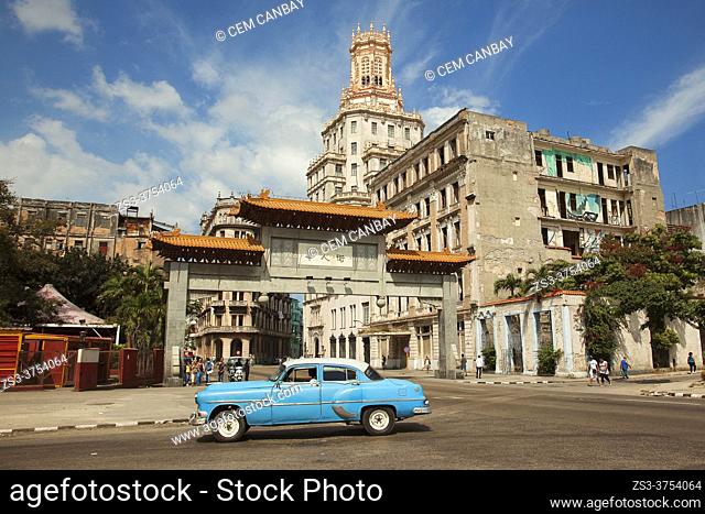Old American car used as taxi in front of the entrance of the Chinatown-Barrio Chino at Center Havana , La Habana, Cuba, West Indies, Central America