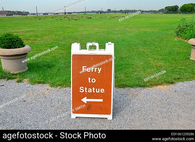 ferry to statue sign and grass or field with geese