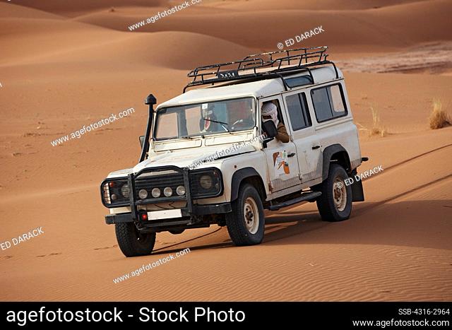 Land Rover on dunes of Erg Chegaga, interior Sahara Desert, Morocco