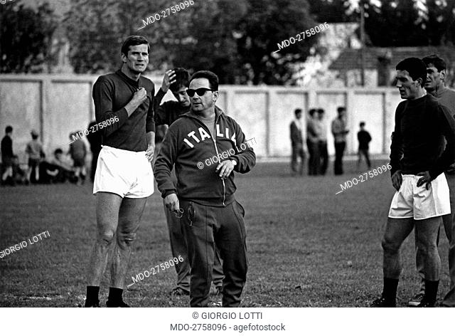 Italian head coach Edmondo Fabbri training Italian national football team. Behind him, Italian football players Giacinto Facchetti
