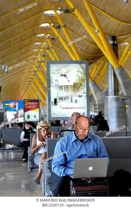 Departure lounge, man working on a laptop computer, Madrid-Barajas Airport, Madrid, Spain, Europe