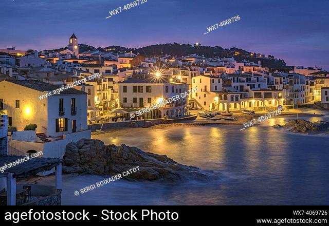Blue hour and sunrise in the fishing village of Calella de Palafrugell, with its boats and white houses, on the Costa Brava coast (EmpordÃ , Girona, Catalonia