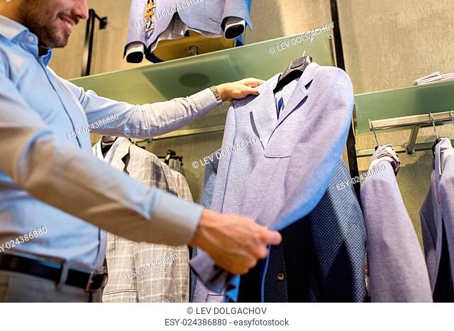 sale, shopping, fashion, style and people concept - close up of man choosing jacket at clothing store