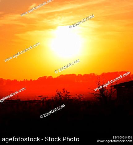 Bright orange sunset in the countryside. Toned image. Shallow depth of field. Selective focus