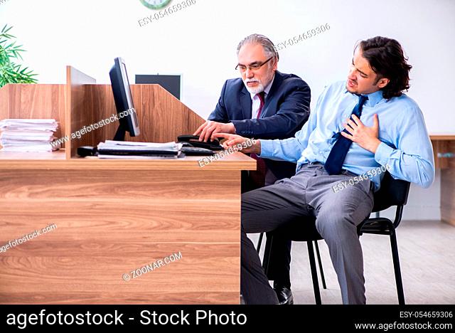 The male employee suffering from heart attack in the office