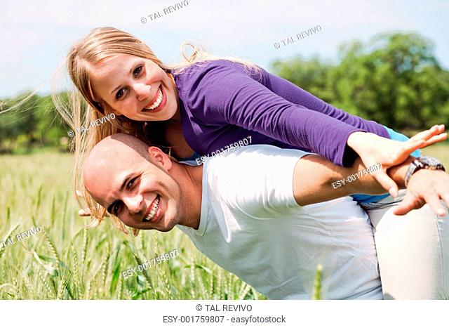 Happy couple enjoying with their arms outstreched