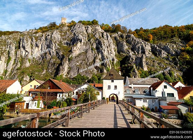 High rocks in the village Essing in Bavaria, Germany at the Altmuehl river on a sunny day in autumn with blue sky and white clouds