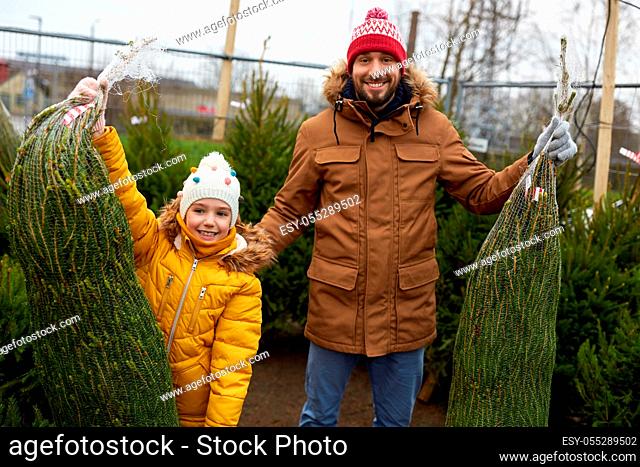happy family buying christmas tree at market