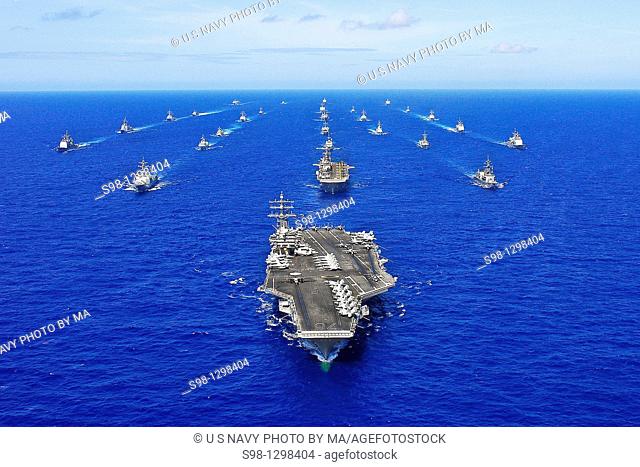 The aircraft carrier USS Ronald Reagan transits the Pacific Ocean with ships assigned to Rim of the Pacific 2010 combined task force as part of a photo exercise...