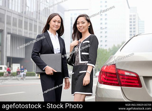 Two Businesswomen Standing On Road