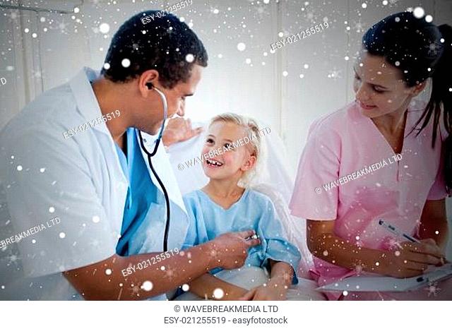 Composite image of a doctor and a nurse examining a little girl