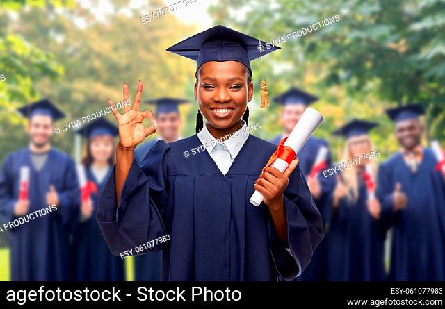 female graduate student with diploma showing ok