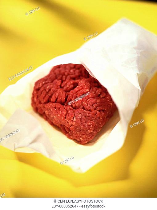 Raw ground beef in crinckled paper