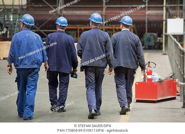 Workers in the factory of MVÂ Werften, a company that recently completed a number of river cruise ships for export to the American company CrystalÂ River