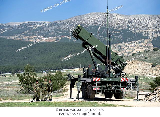 German soldiers stand in front of a .'Patriot' surface-to-air missile of the German Bundeswehr in Kahramanmaras, Turkey, Germany, 25 March 2014
