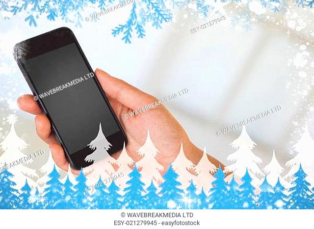 Womans hand holding black smartphone