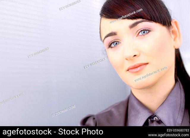 Portrait of pretty young businesswoman at office