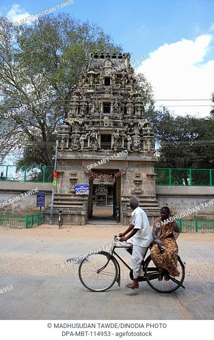Indian couple on bicycle ; Swargeshwara temple ; chola period ; district Kanchipuram ; state Tamilnadu ; India